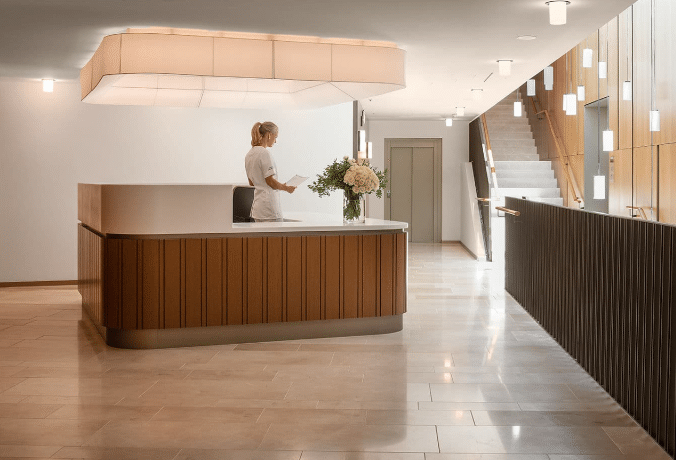 a woman standing at a reception desk