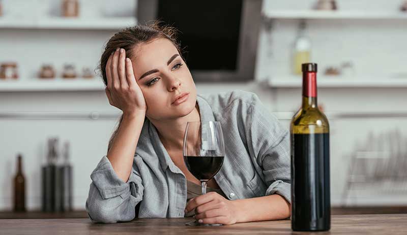 a woman holding a glass of wine